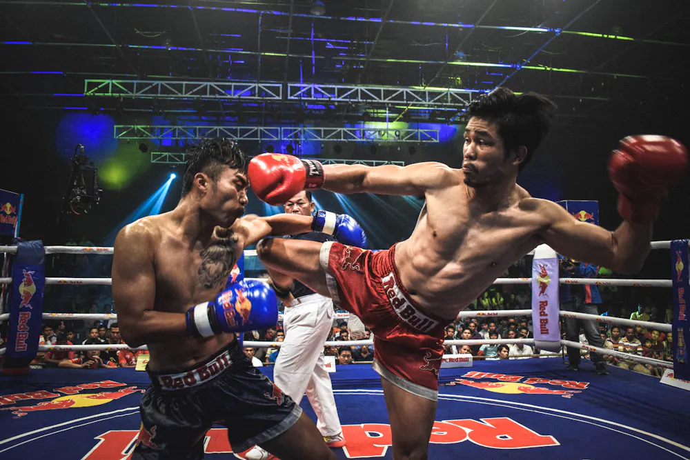 Two athletes practising a kick in a ring