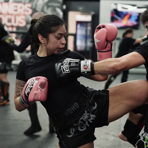 Two people practising a kick during training